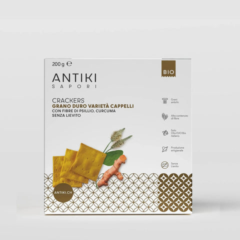 Confezione bianca e oro di crackers Antiki Sapori con curcuma, grano Cappelli e psillio.